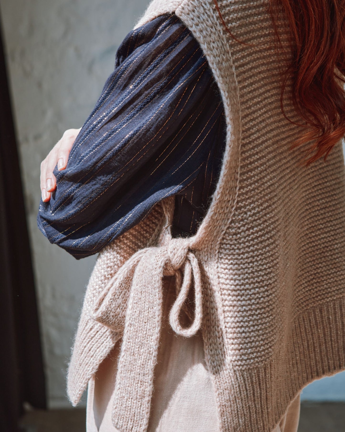 beige sleeveless tie-up sweater