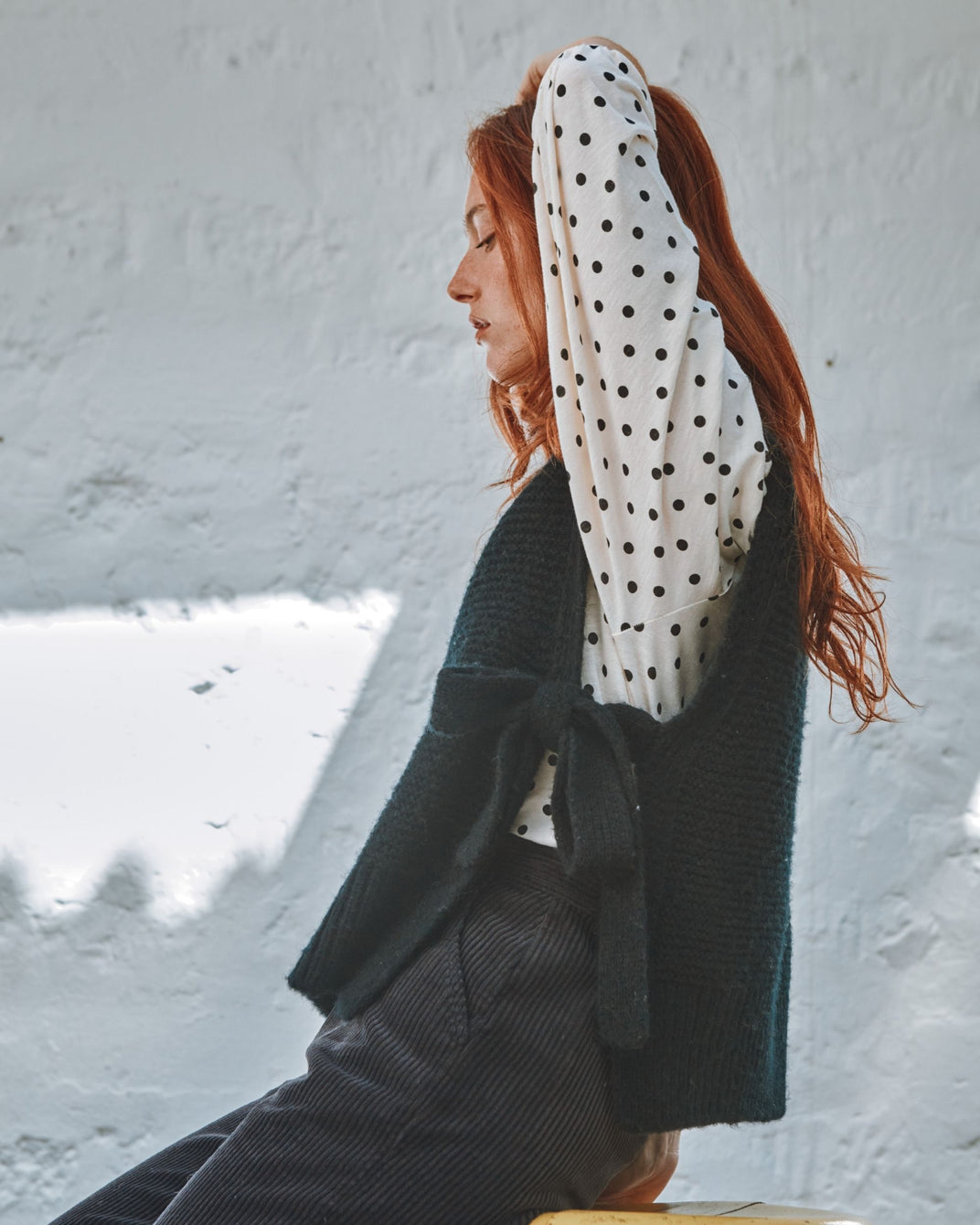 black sleeveless tie-up sweater