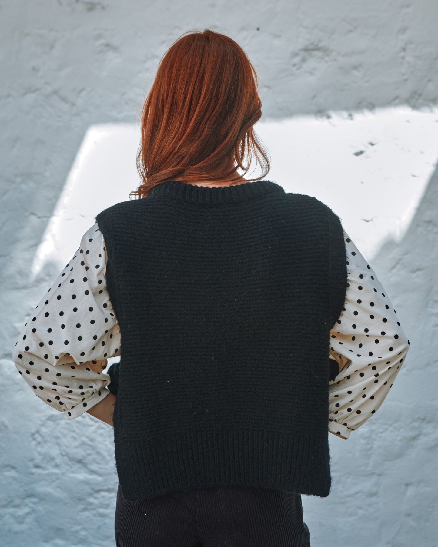 black sleeveless tie-up sweater